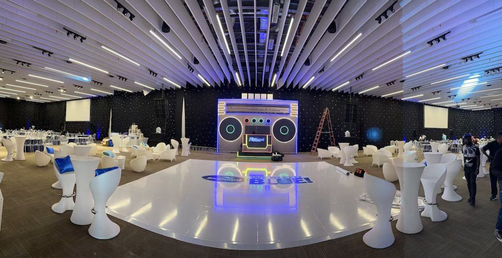 A white lit dance floor and cocktail tables set before guests arrive